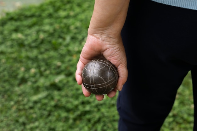 Elderly friends playing petanque