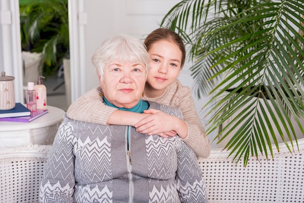 Free photo elderly grandma posing with her granddaughter