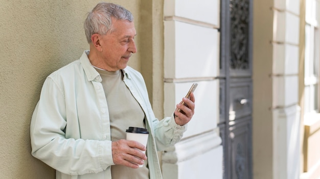 Elderly holding coffee cup medium shot