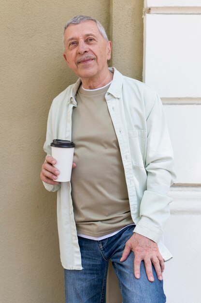 Elderly holding coffee cup