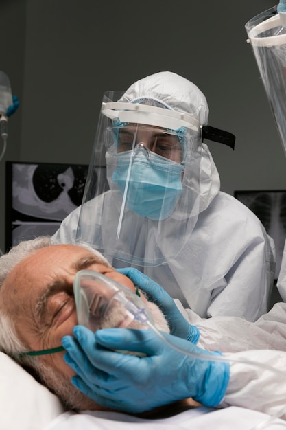 Elderly man breathing with a special equipment at the hospital