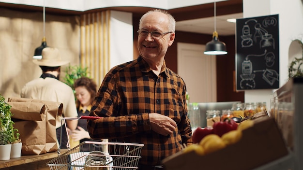 Free photo elderly man buys food in reusable jars