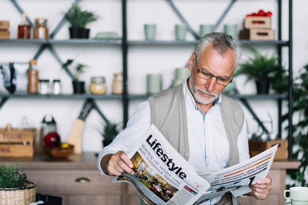 An elderly man reading newspaper
