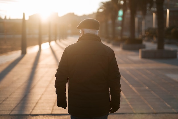 Free photo elderly man taking a stroll