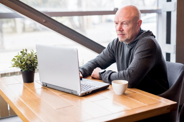 Elderly man using laptop