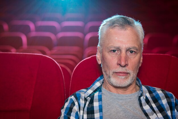 Elderly man watching movie in cinema