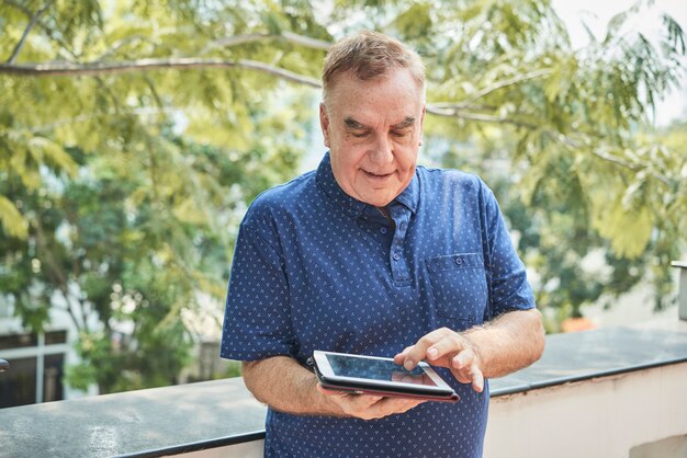 Elderly man with digital tablet