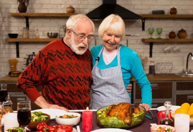 Elderly married couple looking at the cooked turkey