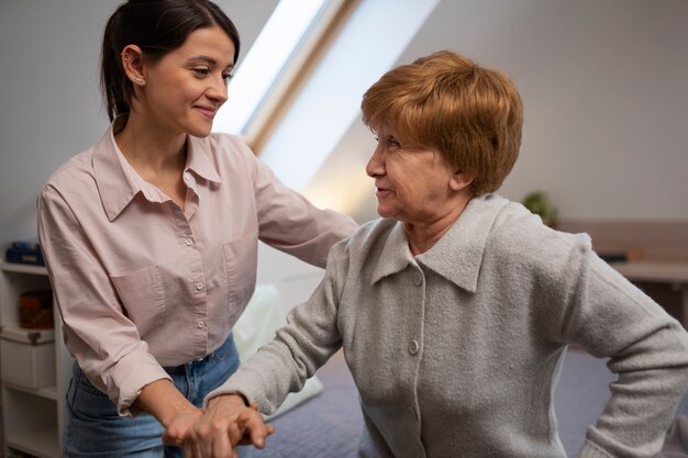 Elderly person being taken care of by female caretaker