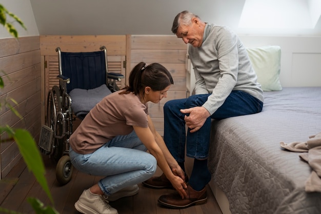 Free photo elderly person being taken care of by female caretaker