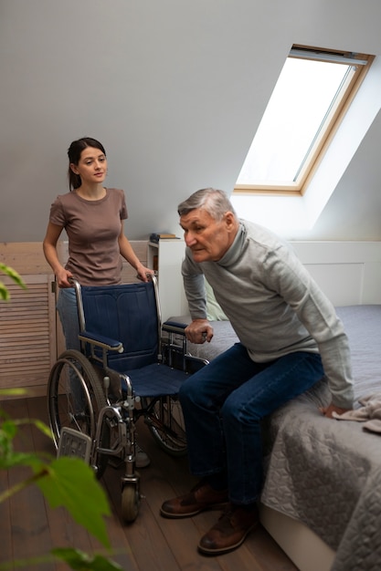 Free photo elderly person being taken care of by female caretaker