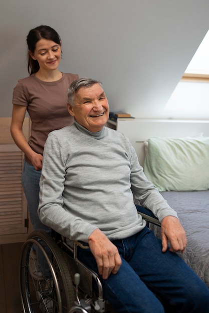 Free photo elderly person being taken care of by female caretaker