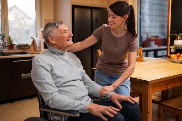 Elderly person being taken care of by female caretaker