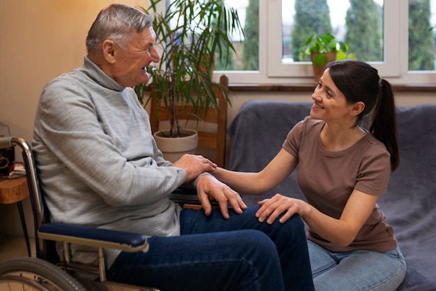 Free photo elderly person being taken care of by female caretaker