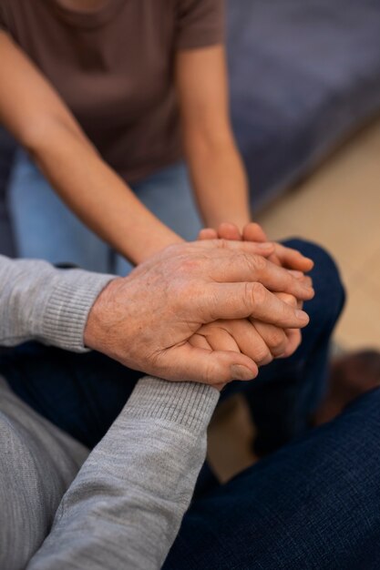 Elderly person being taken care of by female caretaker