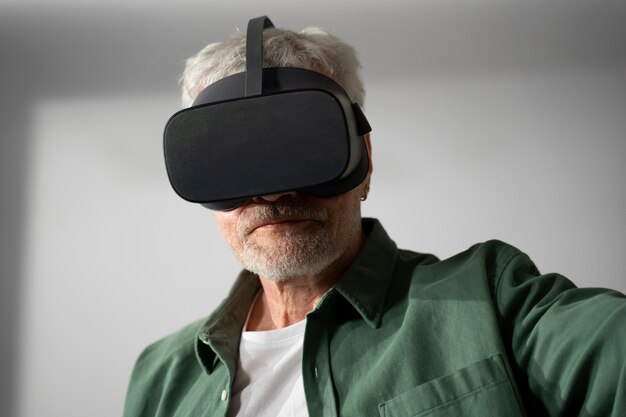 Elderly person using vr set for game immersion