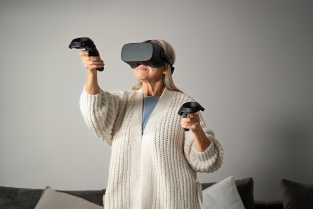 Free photo elderly person using vr set for game immersion