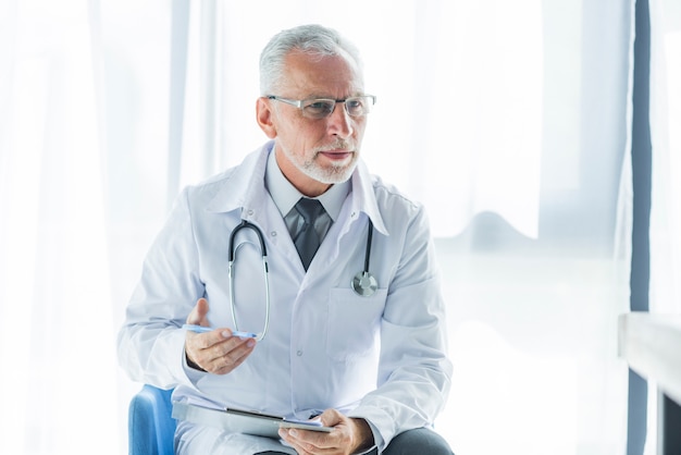 Elderly therapist talking to patient