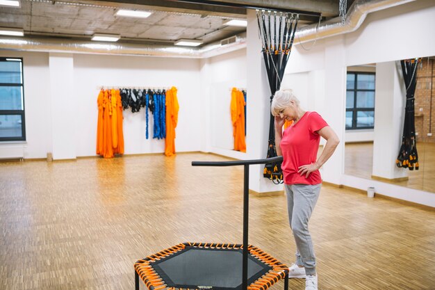 Elderly woman in fitness studio