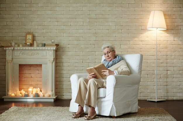 Elderly woman focused on reading