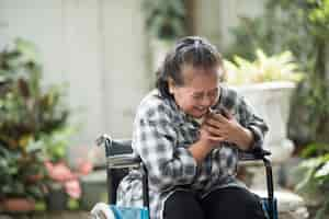 Free photo elderly woman have heart disease sitting on wheelchair