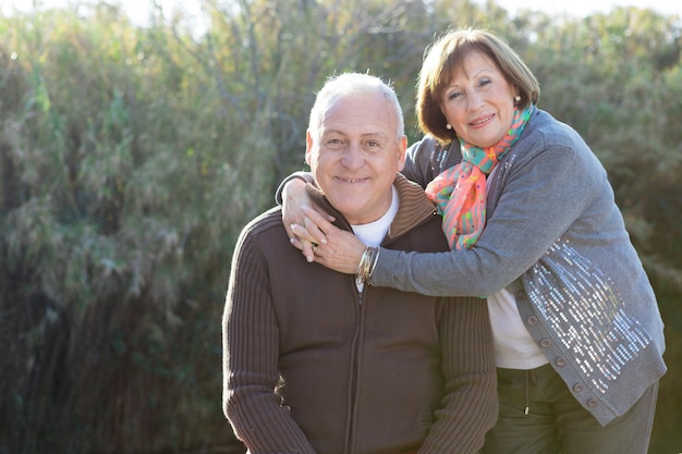 Elderly woman hugging her husband