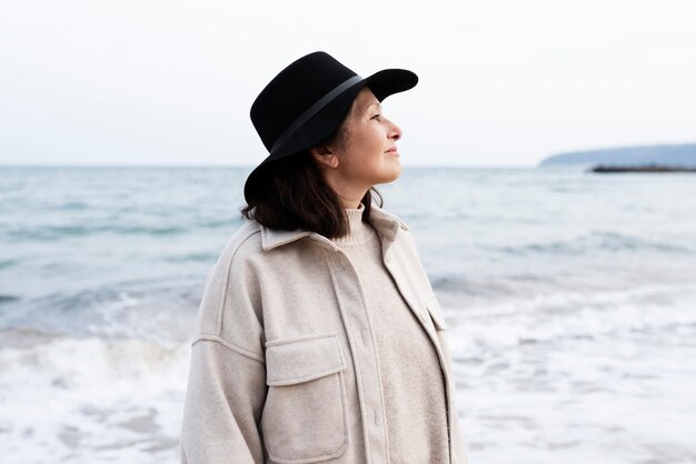 Elderly woman walking by seaside