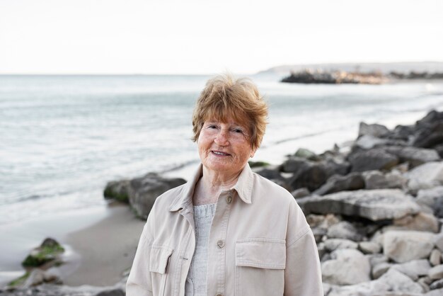 Elderly woman walking by seaside