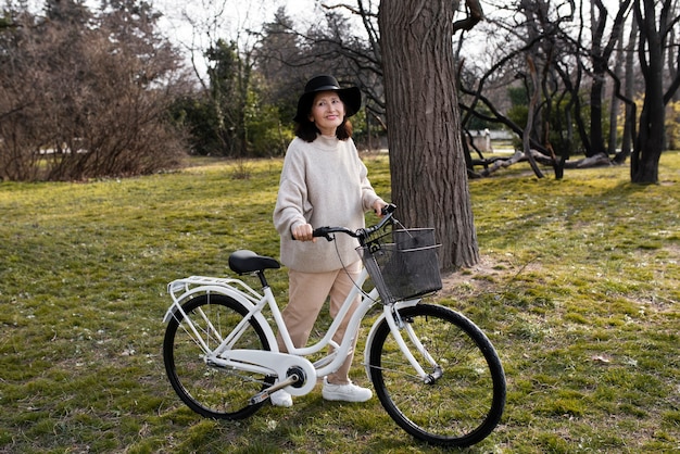 Elderly woman walking with her bike