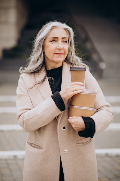 Free photo elderly woman with food take away boxes