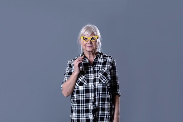 Elderly woman with party glasses
