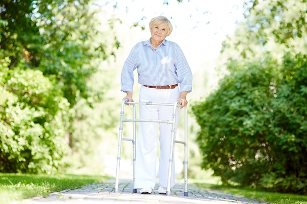 Free photo elderly woman with walker at the park