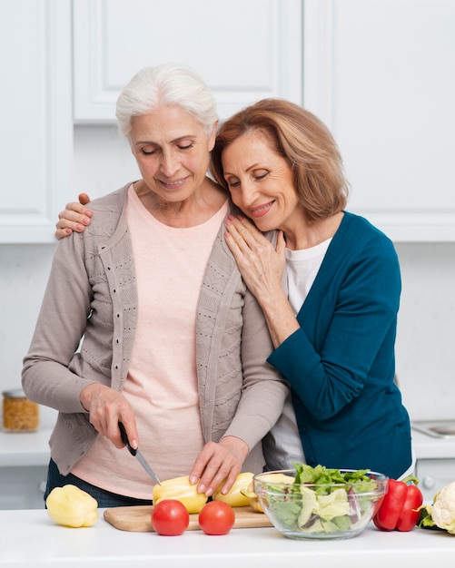 Elderly women cutting vegetables