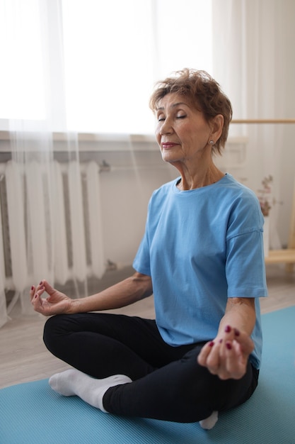 Elderly women doing yoga at home