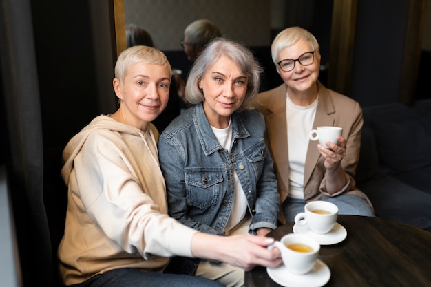 Elderly women drinking coffee during a gathering