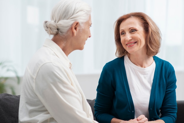 Free photo elderly women looking at each other