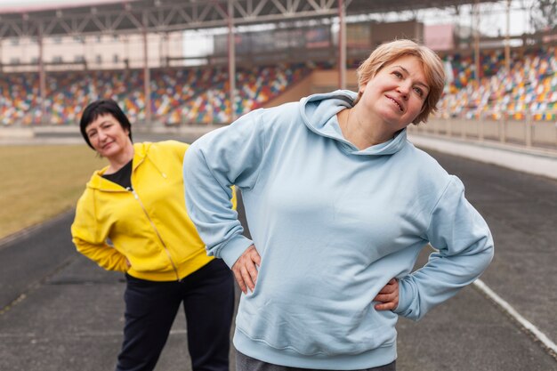 Elderly women stretching on stadium