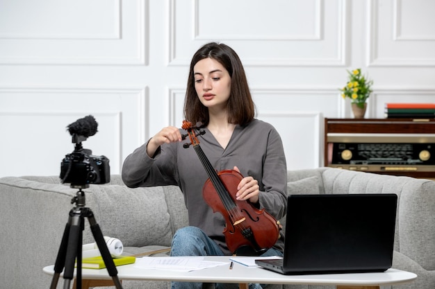 Электронное обучение удаленно дома дает уроки игры на скрипке молодая милая красивая девушка объясняет