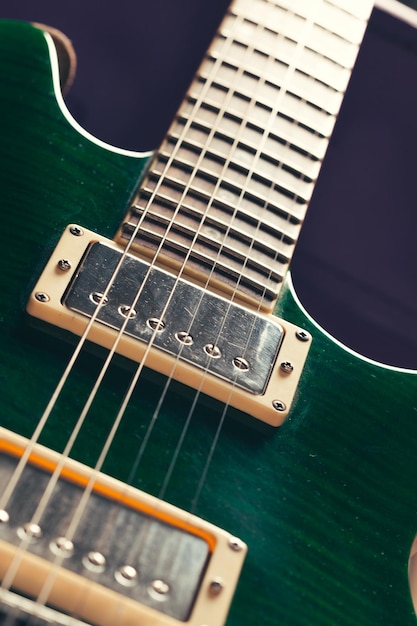 Electric guitar body and neck detail on wooden background