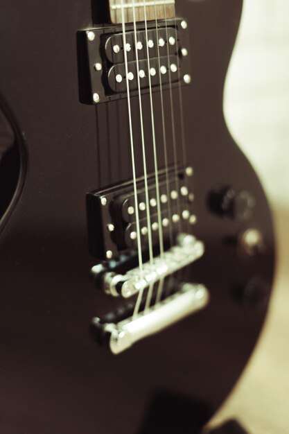 Electric guitar body and neck detail on wooden background