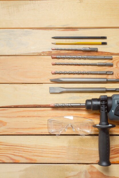 Electric hammer drill lies on a wooden table