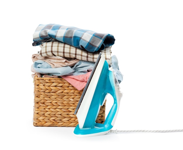 Free photo electric iron and pile of clothes
