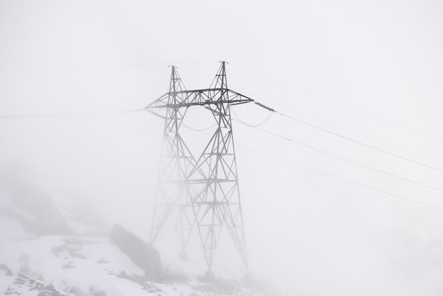 Free photo electric pole on a foggy day