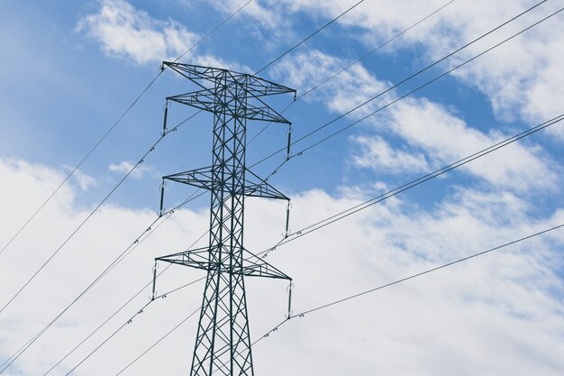 Electric towers with a blue cloudy sky in the background