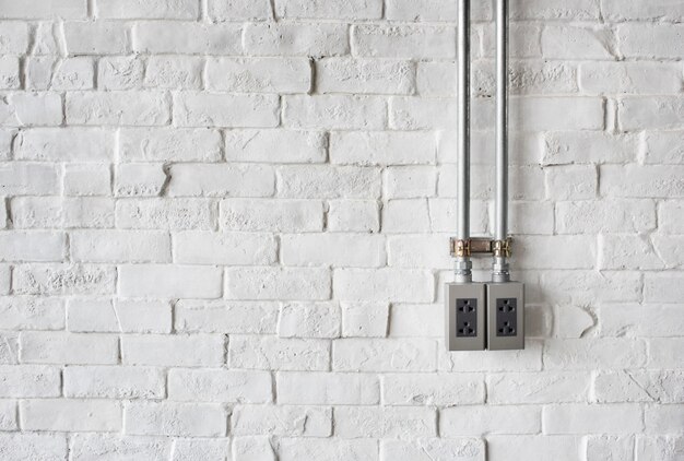 Electrical Socket on a White Painted Brick Wall