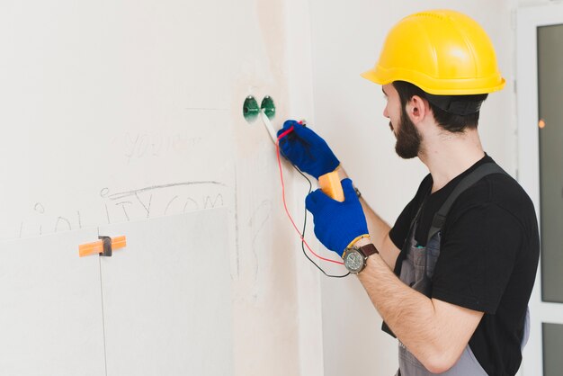 Electrician working with cables