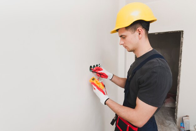 Electrician working with measure tool