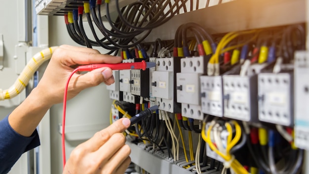 electricians-hands-testing-current-electric-control-panel_34936-1509.jpg