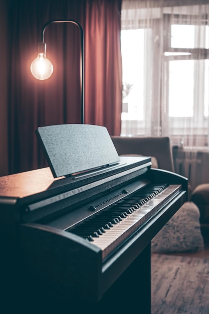 Electronic piano in the interior of the room on a blurred background