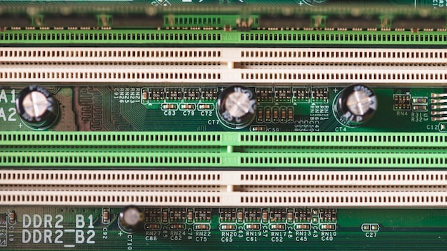 Free photo electronics components on modern pc computer motherboard with ram connector slot